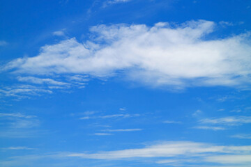 White clouds spread across the vibrant blue sky