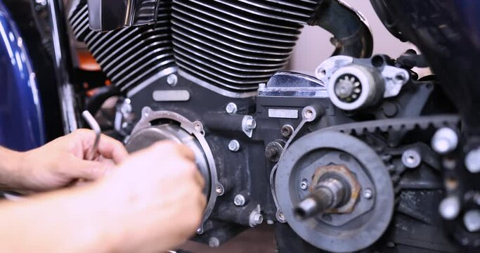Mechanic using wrench and socket on motorcycle cylinder head 4k movie