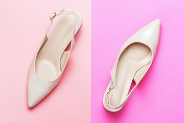 Beige female shoes on pink background close up top view.