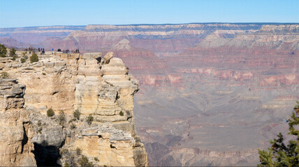 tourists look at a large canyon
