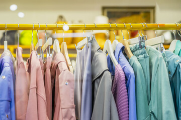 Colorful assortment of casual youth women's clothes on hanger, View through shop window. Seasonal sale concept