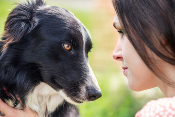 Beautiful girl and her border collie dog close-up