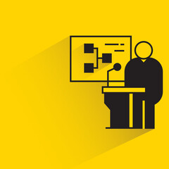 speaker on podium and diagram on yellow background