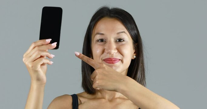 young woman pointing out yo a mobile phone