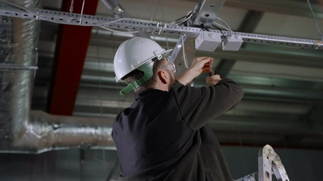 repairing electrical works in industrial building, connecting modern equipment