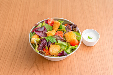 mixed lettuce sprout salad, chicken nuggets, green asparagus, cherry tomatoes and mayonnaise sauce