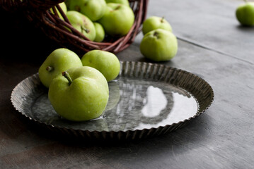 Natural green apples from the home garden on a dark background.
