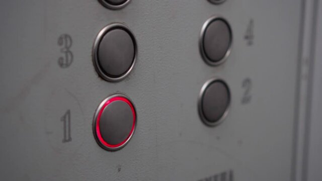A man in a shabby old elevator presses the button for the first floor. A live camera, it feels unsettling.