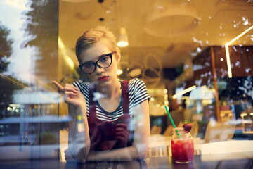 pretty woman sitting in cafe cocktail vacation lifestyle