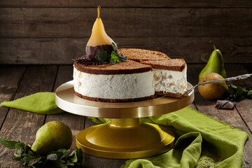 Sliced cheesecake with chocolate shortbread and poached pear