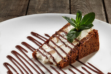 Slice of cheesecake on chocolate shortcrust pastry with poached pear