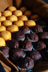 black basket with freshly baked chocolate and plain cupcakes