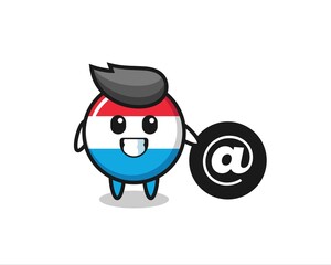Cartoon Illustration of luxembourg flag badge standing beside the At symbol