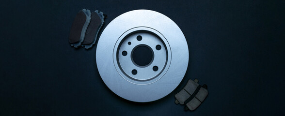 Car service. Auto motor mechanic spare or automotive piece on dark background. New metal car part. Repair and vehicle service with space for text.