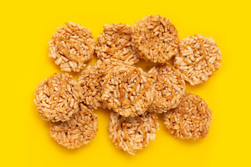Rice cracker with coconut palm sugar on yellow background.