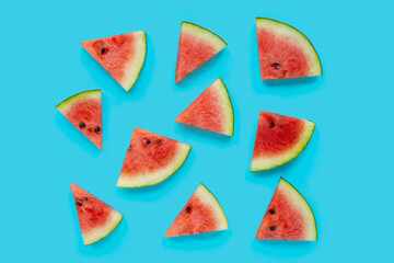 Watermelon slices on blue background. Top view
