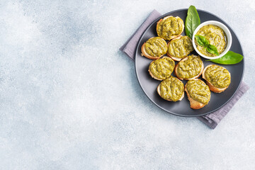 Sandwiches with pesto sauce, fresh basil leaves and garlic. A delicious healthy snack copy space