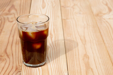 Americano Black Coffee on wooden table in the morning. Iced coffee.