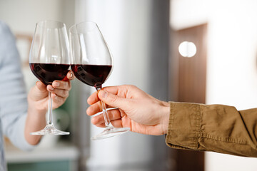 Smiling mid aged couple drinking red wine