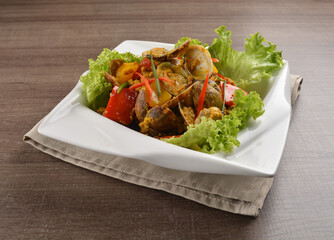 stir fried flower clam shell seafood with sambal spicy chilli sauce on wood background asian halal menu