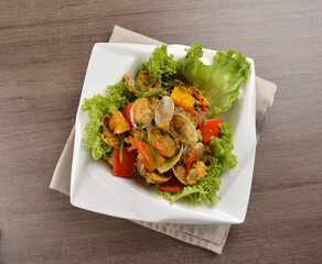 stir fried flower clam shell seafood with sambal spicy chilli sauce on wood background asian halal menu