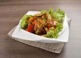 stir fried flower clam shell seafood with sambal spicy chilli sauce on wood background asian halal menu