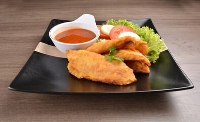 deep fried crispy fish fillet seafood with sambal spicy chilli sauce in bowl on wood background asian halal menu