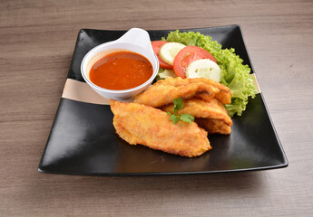 deep fried crispy fish fillet seafood with sambal spicy chilli sauce in bowl on wood background asian halal menu