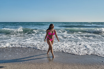 young african american woman coming out of the sea - Powered by Adobe