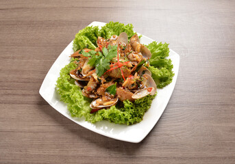 stir fried flower clam shell seafood with sambal spicy chilli sauce on wood background asian halal menu