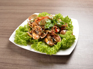stir fried flower clam shell seafood with sambal spicy chilli sauce on wood background asian halal menu