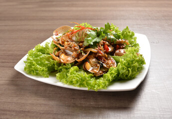 stir fried flower clam shell seafood with sambal spicy chilli sauce on wood background asian halal menu