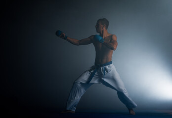 Obraz na płótnie Canvas Taekwondo action isolated by a young man
