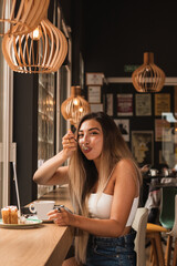 young beautiful woman eating a pie and working on the computer