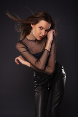 Obraz premium Portrait of an attractive female model posing in sparkling see through shirt