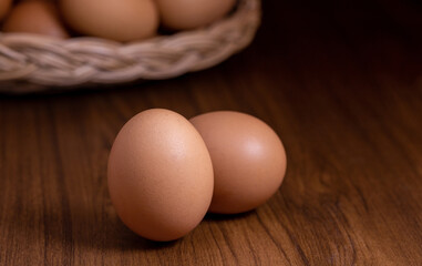 Close-up of chicken eggs on wooden table in the kitchen, organic food