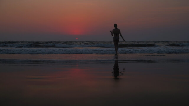 Silhouette of a female at Arambol Beach at sunset