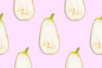 Seamless pattern of cut in half ripe eggplants on a pink background