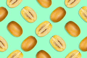 Seamless pattern of yellow and cut in half ripe juicy green kiwi on a turquoise background