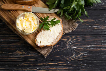 butter, bread, parsley on a wooden background
