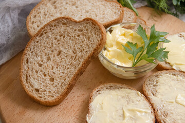 butter, bread, parsley on a wooden background
