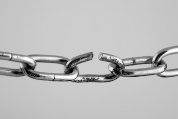 Broken silver metal chain, concept of freedom.