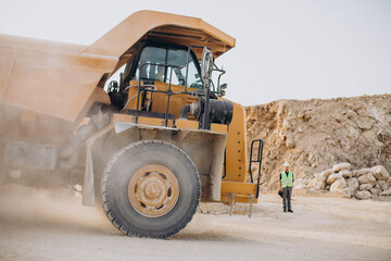 Male worker with bulldozer in sand quarry