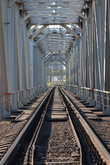 Fototapeta na wymiar A railway for trains passing through a cast-iron bridge.