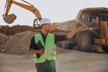 Male worker with bulldozer in sand quarry