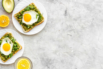 Toasts with eggs and avocado cream and spinach. Top view