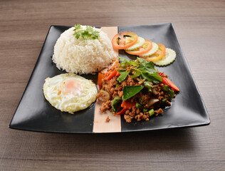 stir fried minced chicken meat in spicy chilli  sauce with white rice and fried egg on wood background asian halal set lunch menu