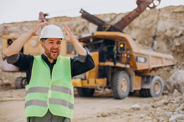 Male worker with bulldozer in sand quarry