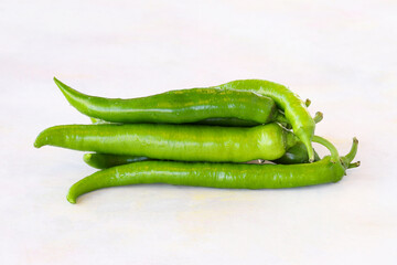 Green pepper on a white wooden background