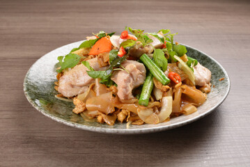 wok fried noodle phad Thai with chicken meat on wood background asian halal set lunch menu